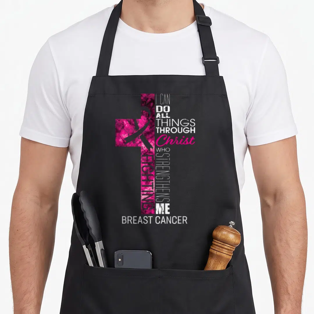 Cross breast cancer awareness aprons - Pink mottled cross with awareness ribbon and stacked white and purple typography — shown on a black cotton canvas apron against a white background