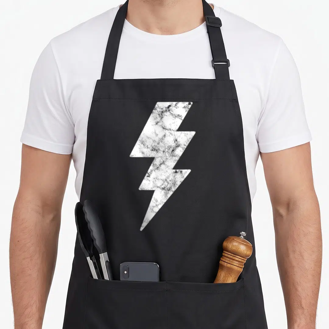 Funny lightning lighting bolt apron - Distressed white lightning bolt graphic centered on grey background — shown on a black cotton canvas apron against a white background