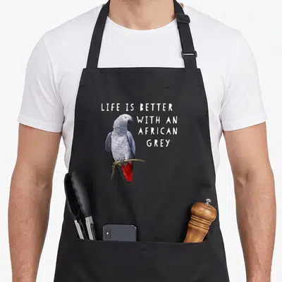 Better african aprons - Photo of grey parrot with red tail perched on branch next to white stacked text — shown on a black cotton canvas apron against a white background
