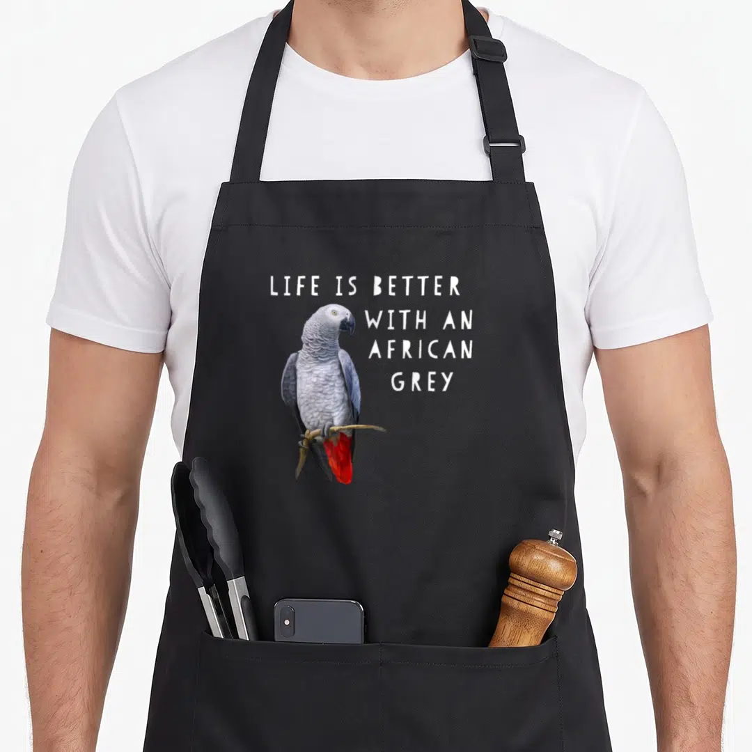 Better african aprons - Photo of grey parrot with red tail perched on branch next to white stacked text — shown on a black cotton canvas apron against a white background