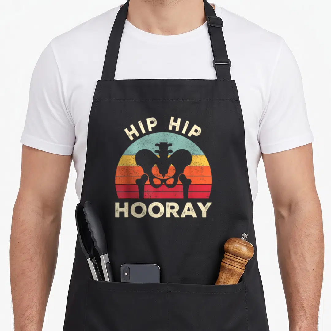 Surgery hip apron - Grey pelvis silhouette over beige teal yellow orange red striped semi-circle with arched Hip Hip — shown on a black cotton canvas apron against a white background
