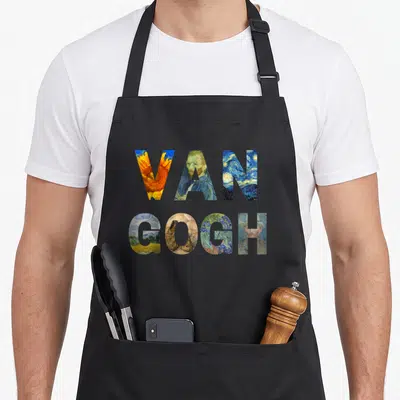 Tribute van gogh apron - VAN GOGH text filled with sunflowers, portraits, and starry night scenes in blue and yellow — shown on a black cotton canvas apron against a white background