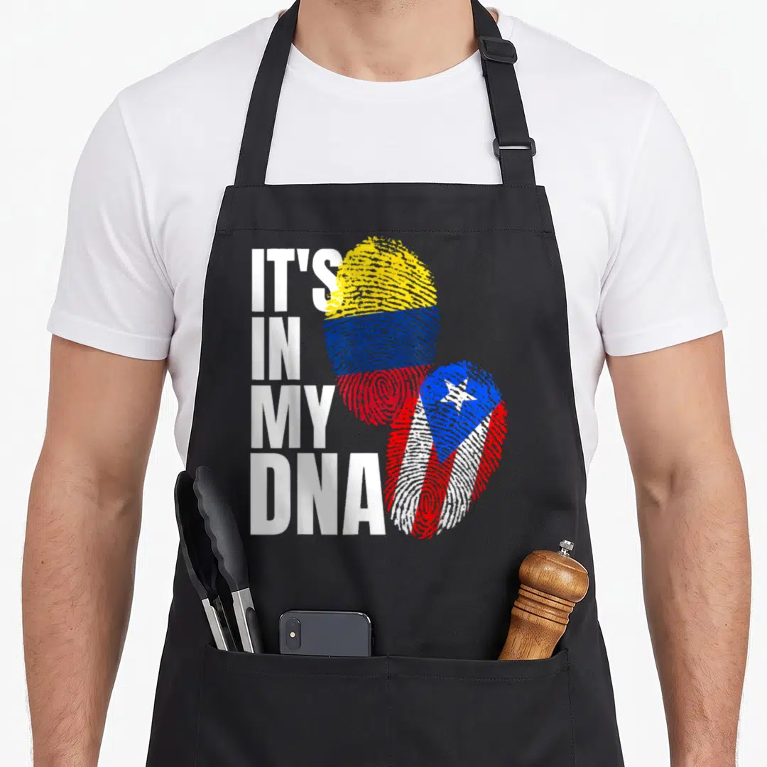 Colombian heritage aprons - IT'S IN MY DNA text next to two fingerprints with flag patterns — shown on a black cotton canvas apron against a white background