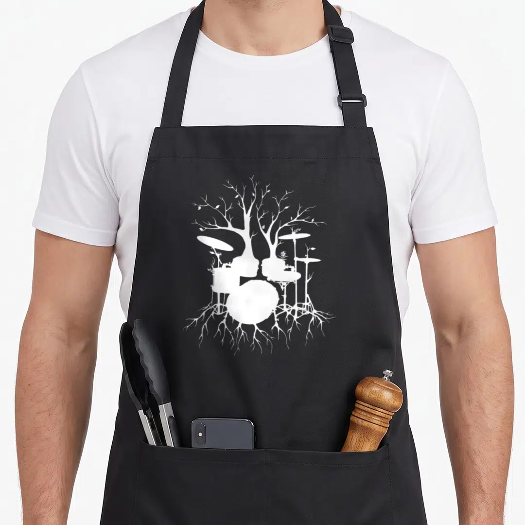 Live drum apron - White silhouette of a drum kit forming a tree with branches and roots on black fabric — shown on a black cotton canvas apron against a white background