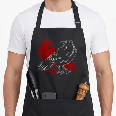 Bird scary gothic apron - Two crows in profile, one white one red, line art style — shown on a black cotton canvas apron against a white background