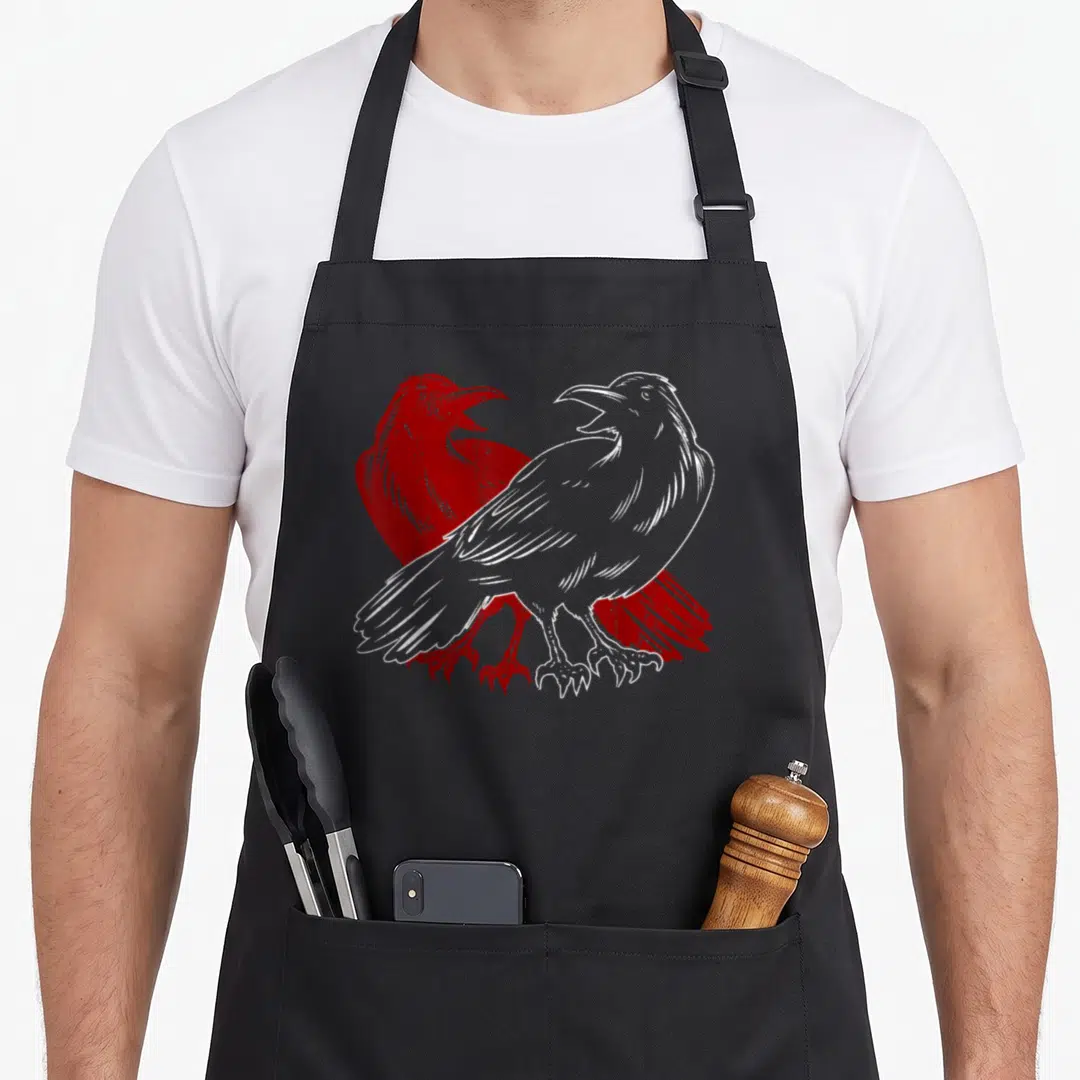 Bird scary gothic apron - Two crows in profile, one white one red, line art style — shown on a black cotton canvas apron against a white background