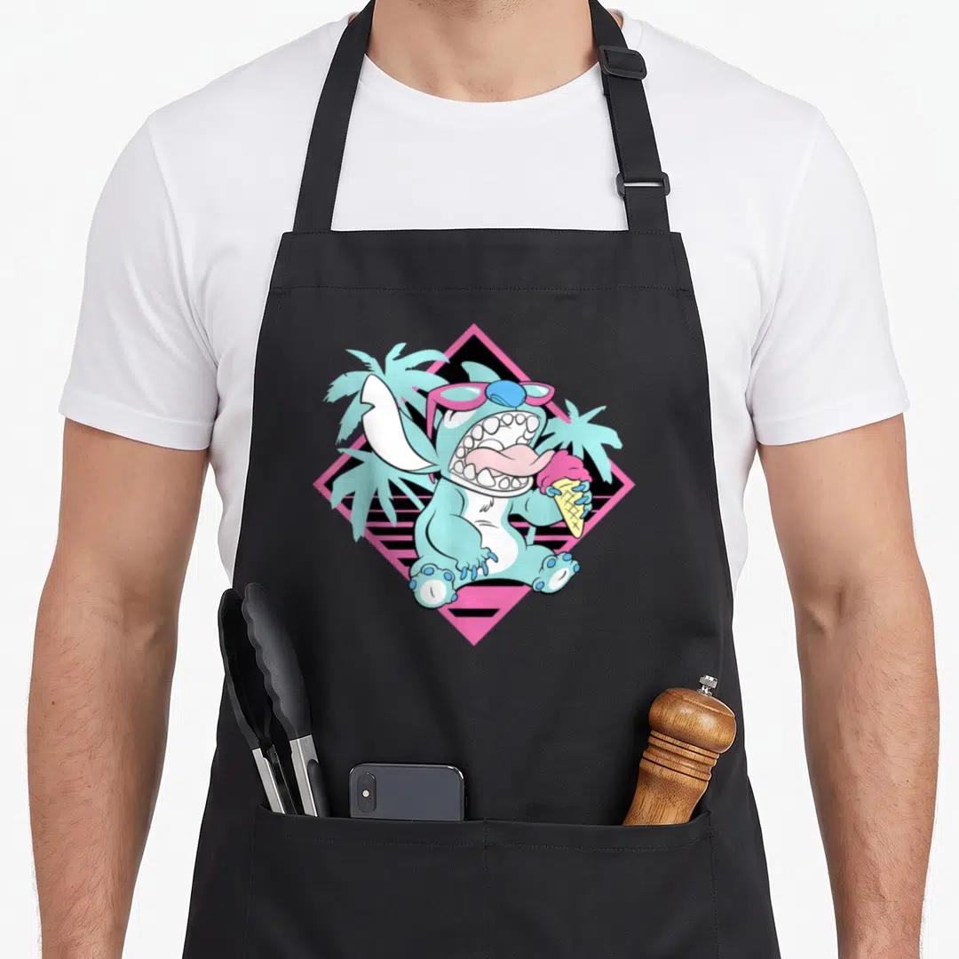 90s ice cream apron - Blue Stitch holding pink ice cream cone in front of two palm trees and striped diamond frame — shown on a black cotton canvas apron against a white background