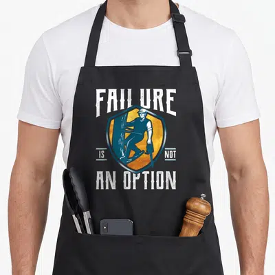 Failure tree apron - Shield with worker chainsaw text Failure Is Not An Option blue yellow white — shown on a black cotton canvas apron against a white background