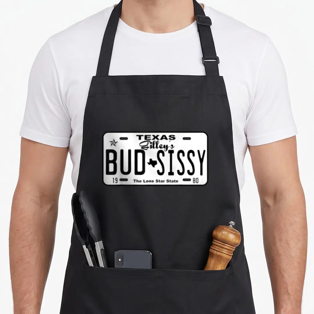 Gilley country apron - White Texas license plate graphic with Bud Sissy text and 1980 date — shown on a black cotton canvas apron against a white background