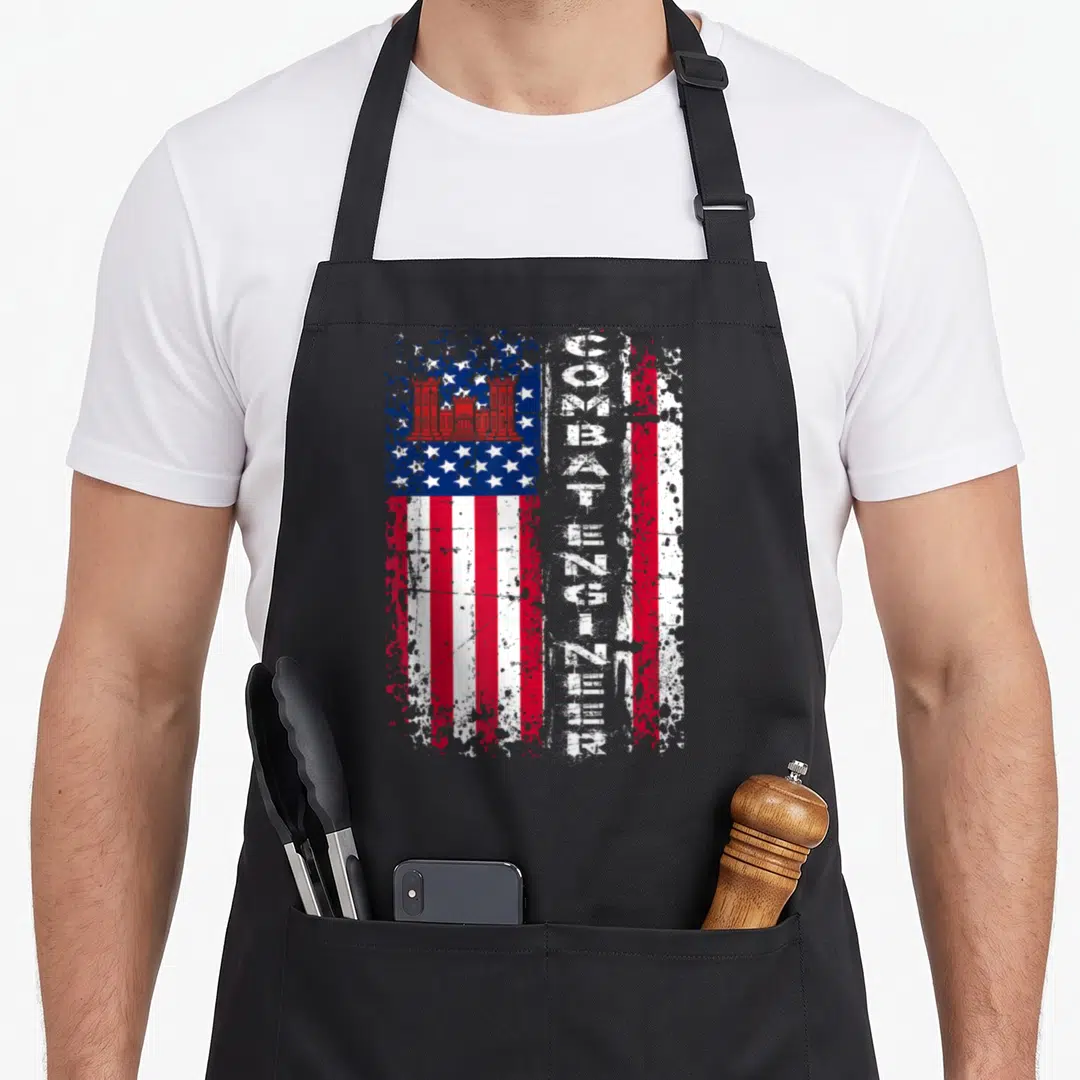 Combat engineer apron - Distressed US flag with vertical COMBAT ENGINEER text and red castle in blue canton — shown on a black cotton canvas apron against a white background