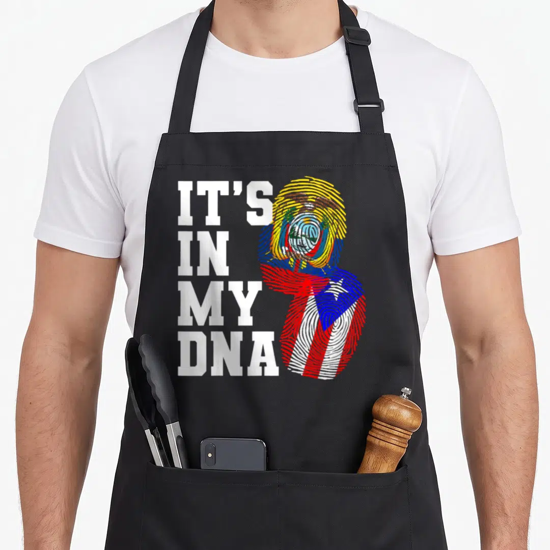Ecuadorian puerto heritage aprons - IT'S IN MY DNA text beside fingerprints with Ecuadorian coat of arms and Puerto — shown on a black cotton canvas apron against a white background