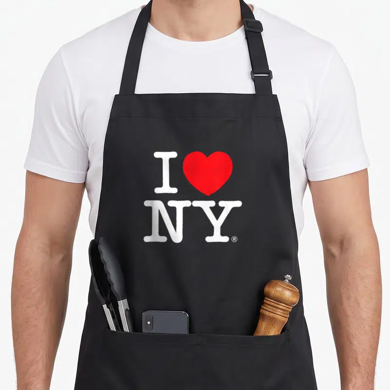 Cute new york apron - White I and NY letters with a red heart shape on grey background — shown on a black cotton canvas apron against a white background