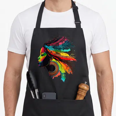 Rainbow african apron - Colorful profile portrait of a woman with rainbow hair and large earring — shown on a black cotton canvas apron against a white background