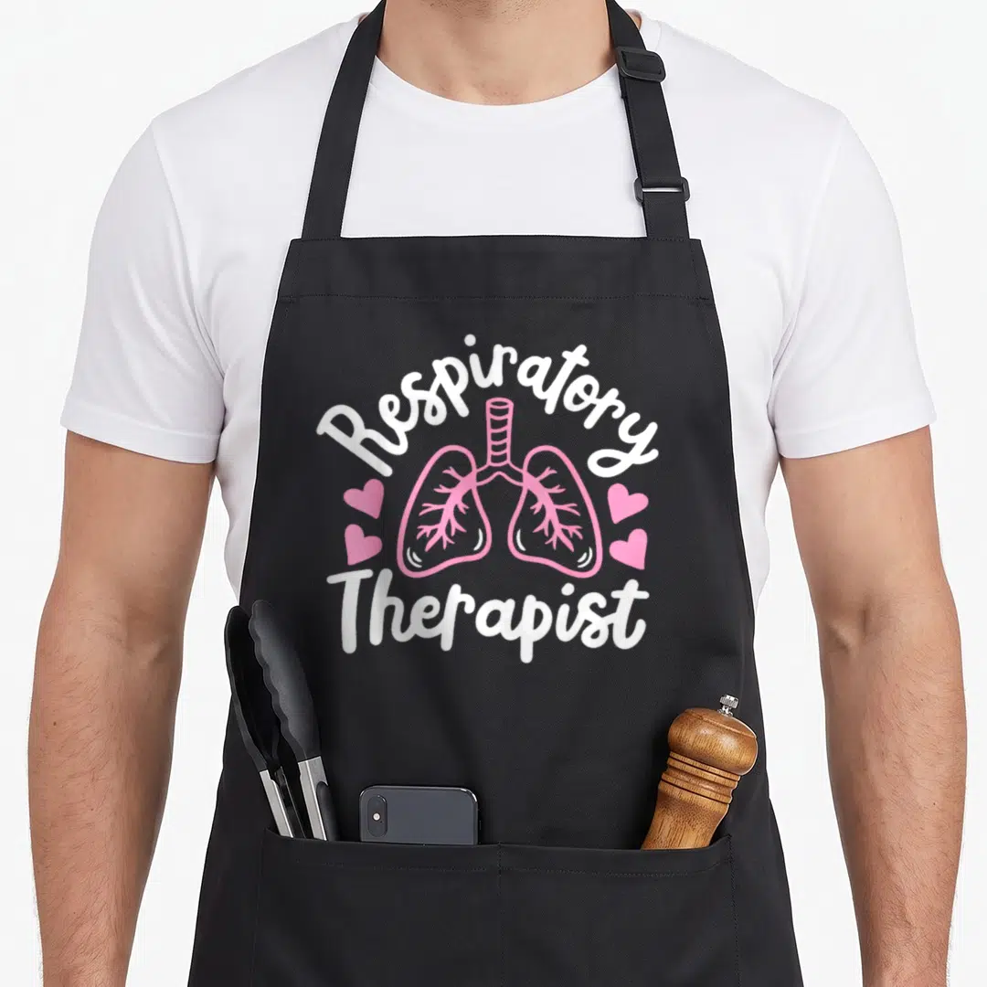 Respiratory of squad apron - Pink cartoon lungs with four hearts and white text reading Respiratory Therapist — shown on a black cotton canvas apron against a white background