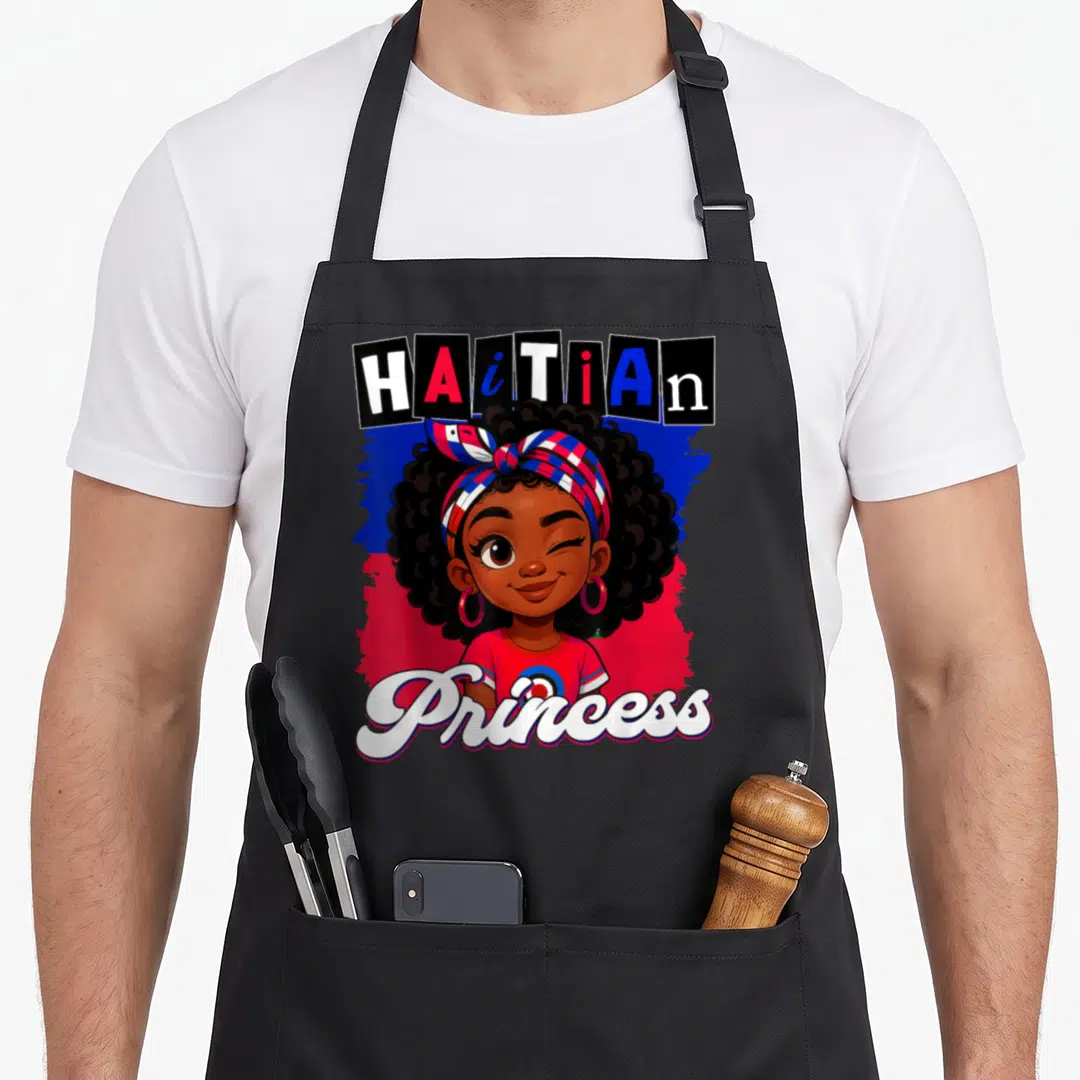 Pride princess apron - Cartoon girl with flag headwrap and HAiTiAn Princess text on blue and red background — shown on a black cotton canvas apron against a white background