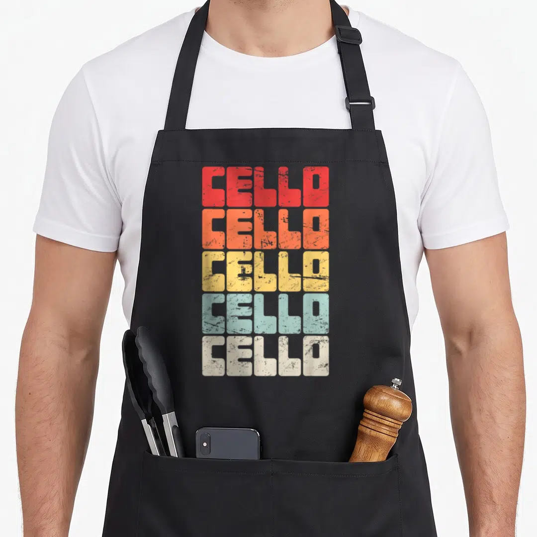 Instructor cello apron - Five stacked lines of CELLO text in red orange yellow light blue and off-white distressed — shown on a black cotton canvas apron against a white background