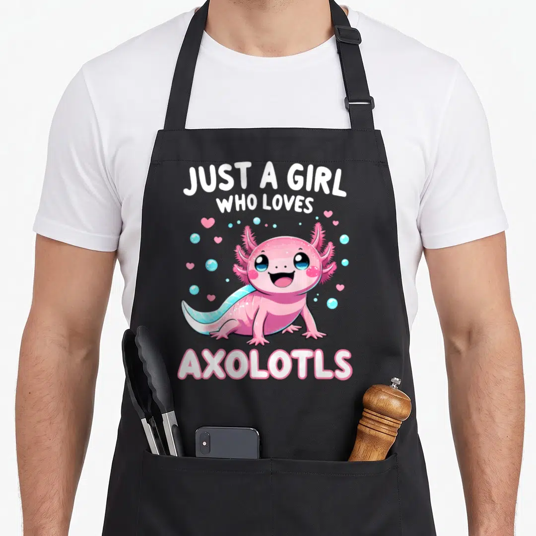 Funny axolotl kawaii apron - Pink cartoon axolotl with blue tail surrounded by hearts and bubbles under white text — shown on a black cotton canvas apron against a white background