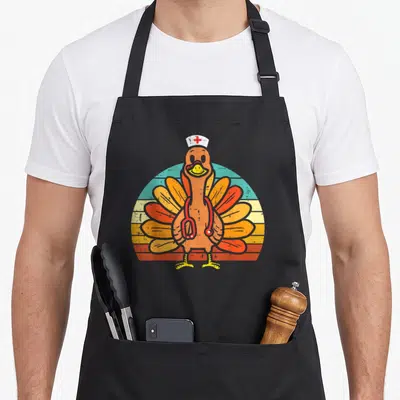 Stethoscope thanksgiving apron - Cartoon turkey wearing nurse hat and stethoscope on retro sunset stripes — shown on a black cotton canvas apron against a white background