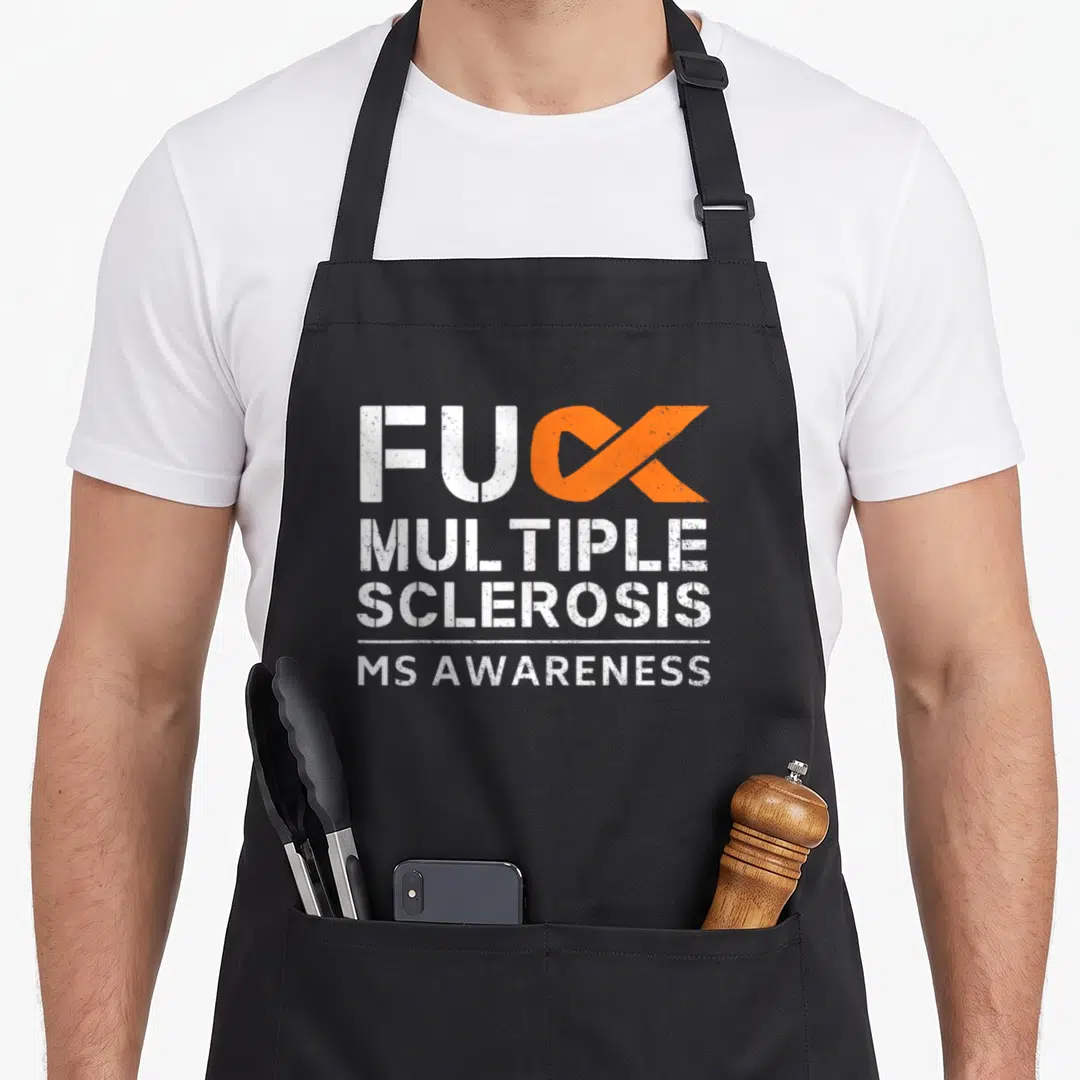Sclerosis ribbon apron - FUC MULTIPLE SCLEROSIS text with orange ribbon replacing K in distressed white font — shown on a black cotton canvas apron against a white background