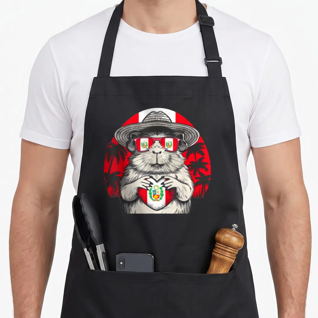 Guinea pride apron - Realistic guinea pig in hat and sunglasses holding a Peruvian flag heart against red background — shown on a black cotton canvas apron against a white background