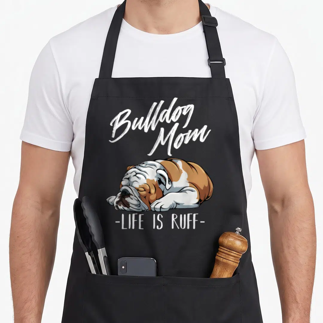 Funny bulldog english aprons - Cartoon brown and white sleeping bulldog with Bulldog Mom Life Is Ruff text — shown on a black cotton canvas apron against a white background