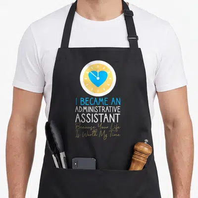 Assistant secretary administrative apron - Clock with blue heart above stacked text in blue white yellow and gold — shown on a black cotton canvas apron against a white background