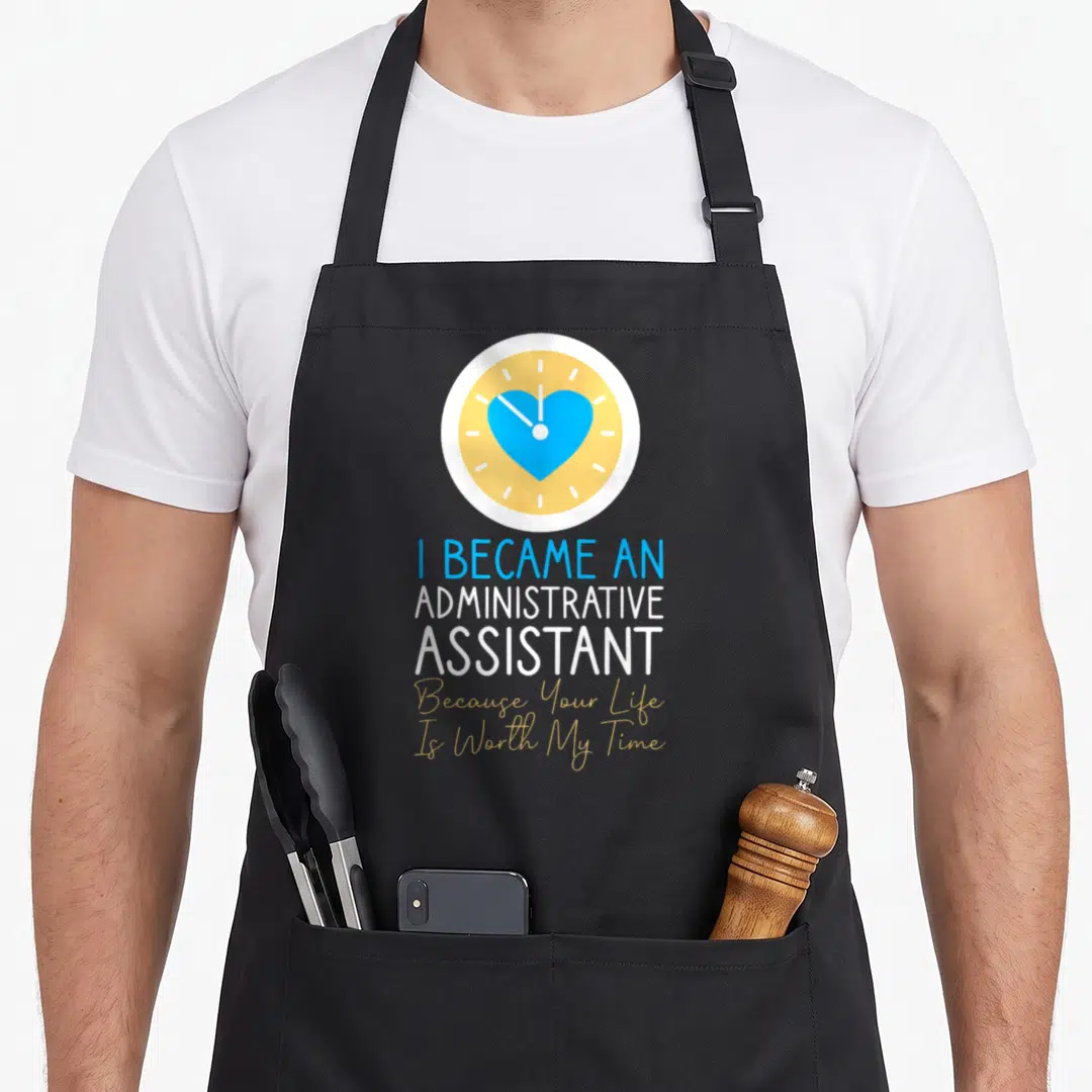 Assistant secretary administrative apron - Clock with blue heart above stacked text in blue white yellow and gold — shown on a black cotton canvas apron against a white background
