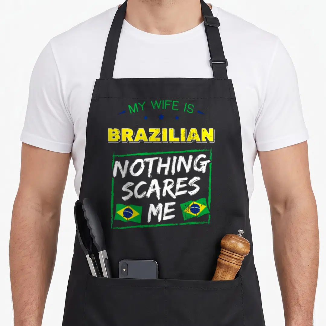 Brazilian wife apron - Stacked text My Wife Is Brazilian Nothing Scares Me with two Brazilian flags and distressed — shown on a black cotton canvas apron against a white background