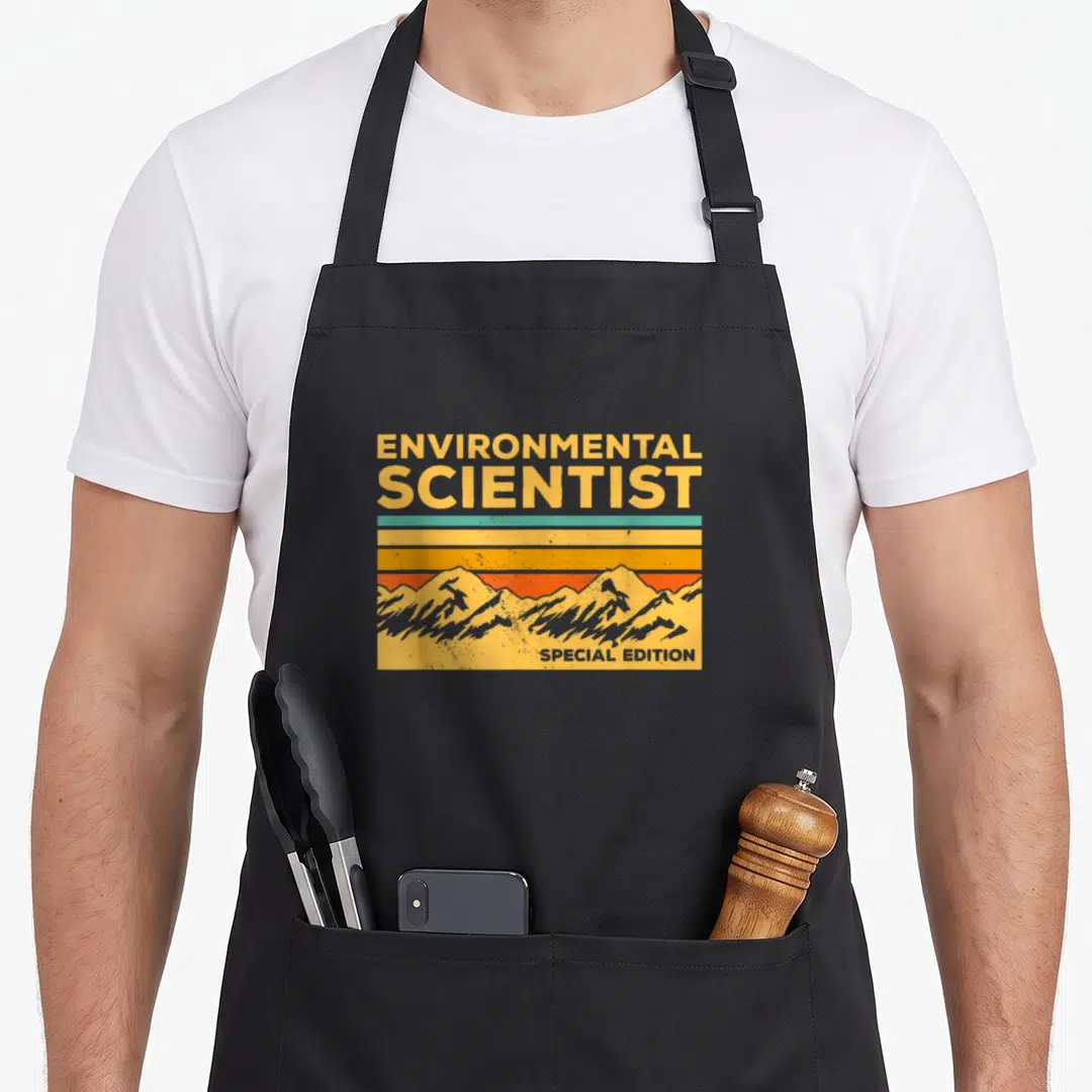 Environmental special aprons - Retro mountain silhouette behind yellow blue orange stripes with ENVIRONMENTAL SCIENTIST — shown on a black cotton canvas apron against a white background