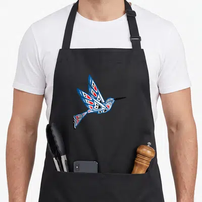 Hummingbird northwest apron - Stylized hummingbird in blue white red black Pacific Northwest tribal art style — shown on a black cotton canvas apron against a white background