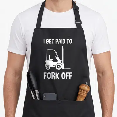 Forklift paid fork apron - White forklift silhouette with I Get Paid To Fork Off text on black background — shown on a black cotton canvas apron against a white background