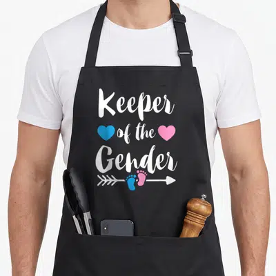 Keeper apron or apron - Stacked text with blue and pink hearts and footprint arrow design — shown on a black cotton canvas apron against a white background