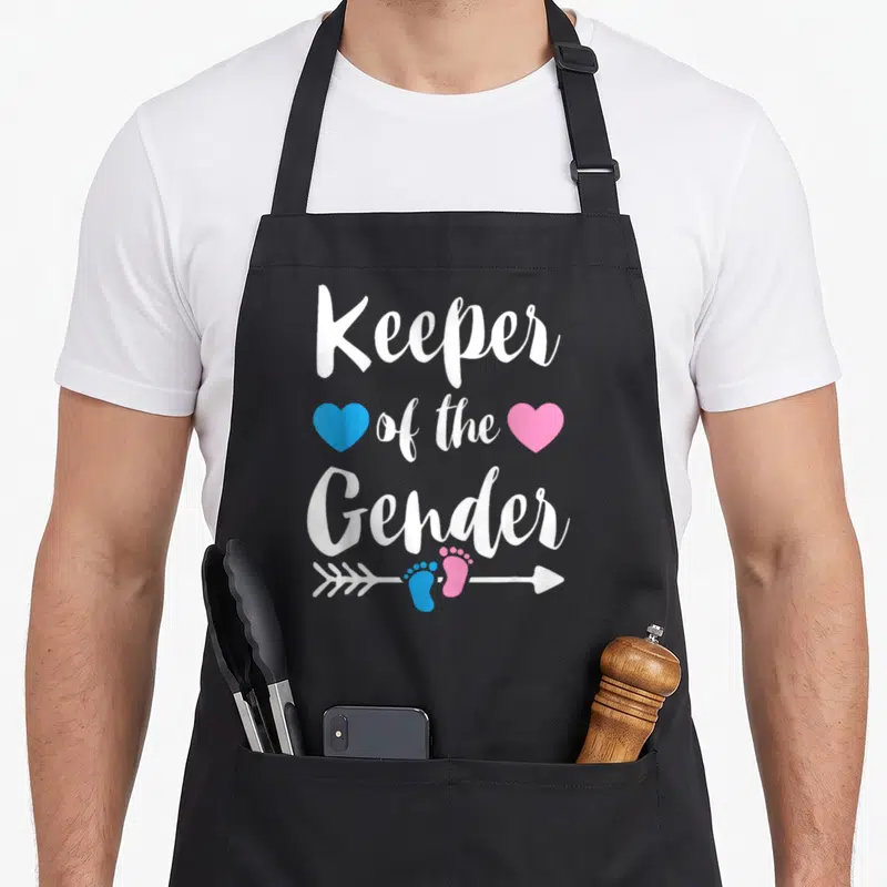 Keeper apron or apron - Stacked text with blue and pink hearts and footprint arrow design — shown on a black cotton canvas apron against a white background