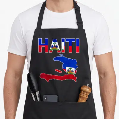 Haitian flag pride apron - HAITI text and map filled with blue red white flag pattern and coat of arms — shown on a black cotton canvas apron against a white background