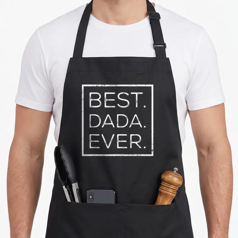 Grandpa dada father day apron - White distressed text reading Best Dada Ever inside a rectangular border — shown on a black cotton canvas apron against a white background