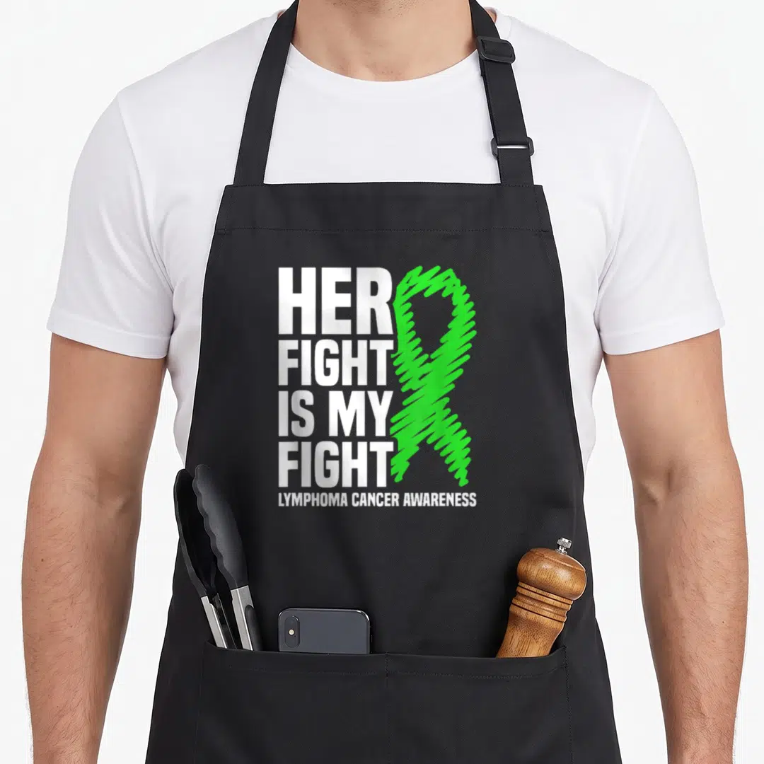 Lymphoma ribbon apron - Stacked white text Her Fight Is My Fight next to a green awareness ribbon — shown on a black cotton canvas apron against a white background