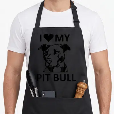 Cute pitbull pit bull apron - Black line-art pit bull head between I ❤️ MY and PIT BULL text — shown on a black cotton canvas apron against a white background