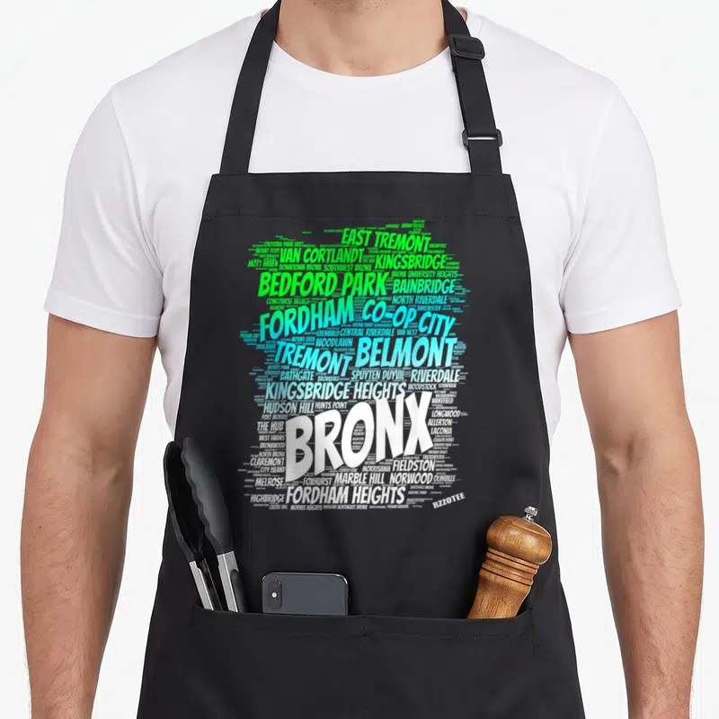 Zoo new york apron - Bronx word cloud in white green and blue neighborhood names — shown on a black cotton canvas apron against a white background