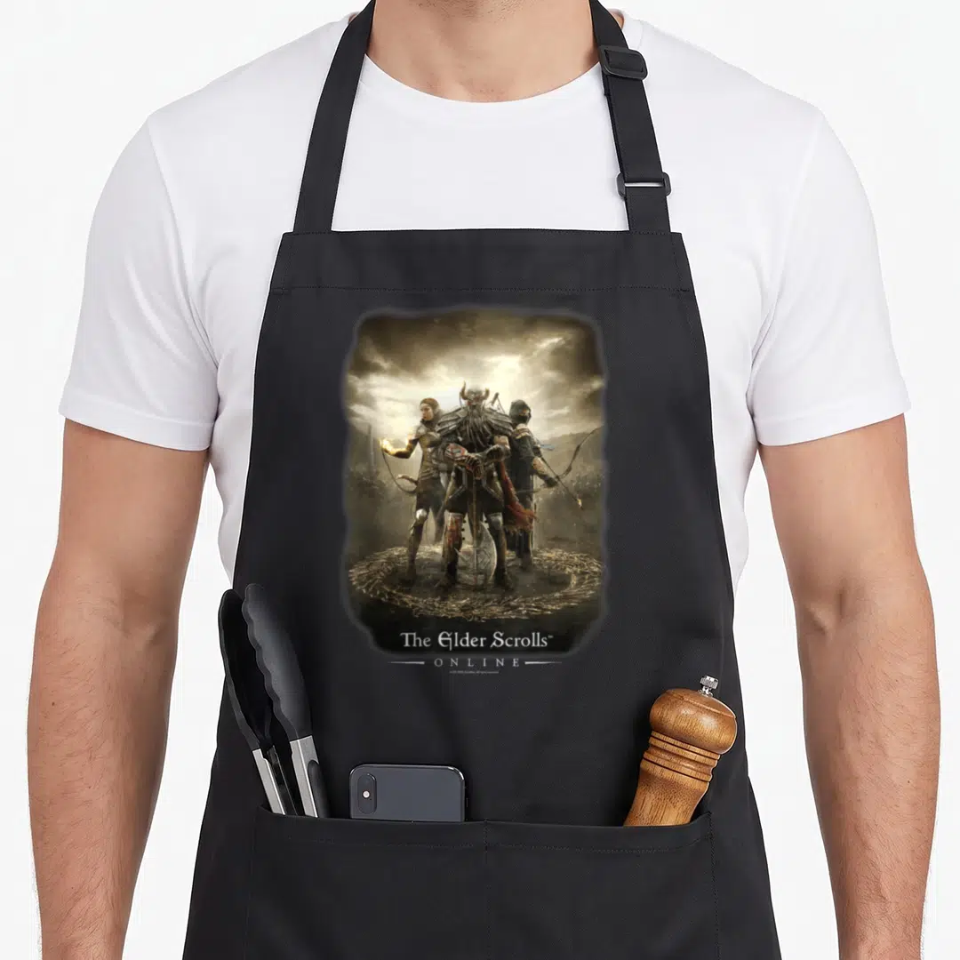Trio video game apron - Three warriors in circle formation under cloudy sky with Elder Scrolls Online text — shown on a black cotton canvas apron against a white background