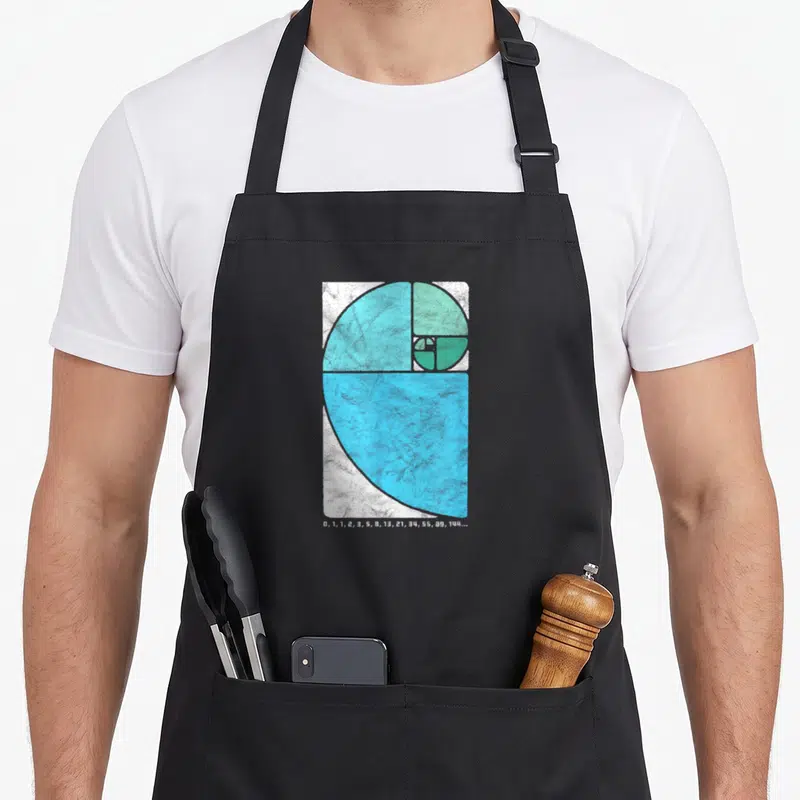 Number golden apron - Blue and teal geometric spiral above white number sequence 0, 1, 1, 2, 3, 5, 8, 13, 21, 34, 55 — shown on a black cotton canvas apron against a white background