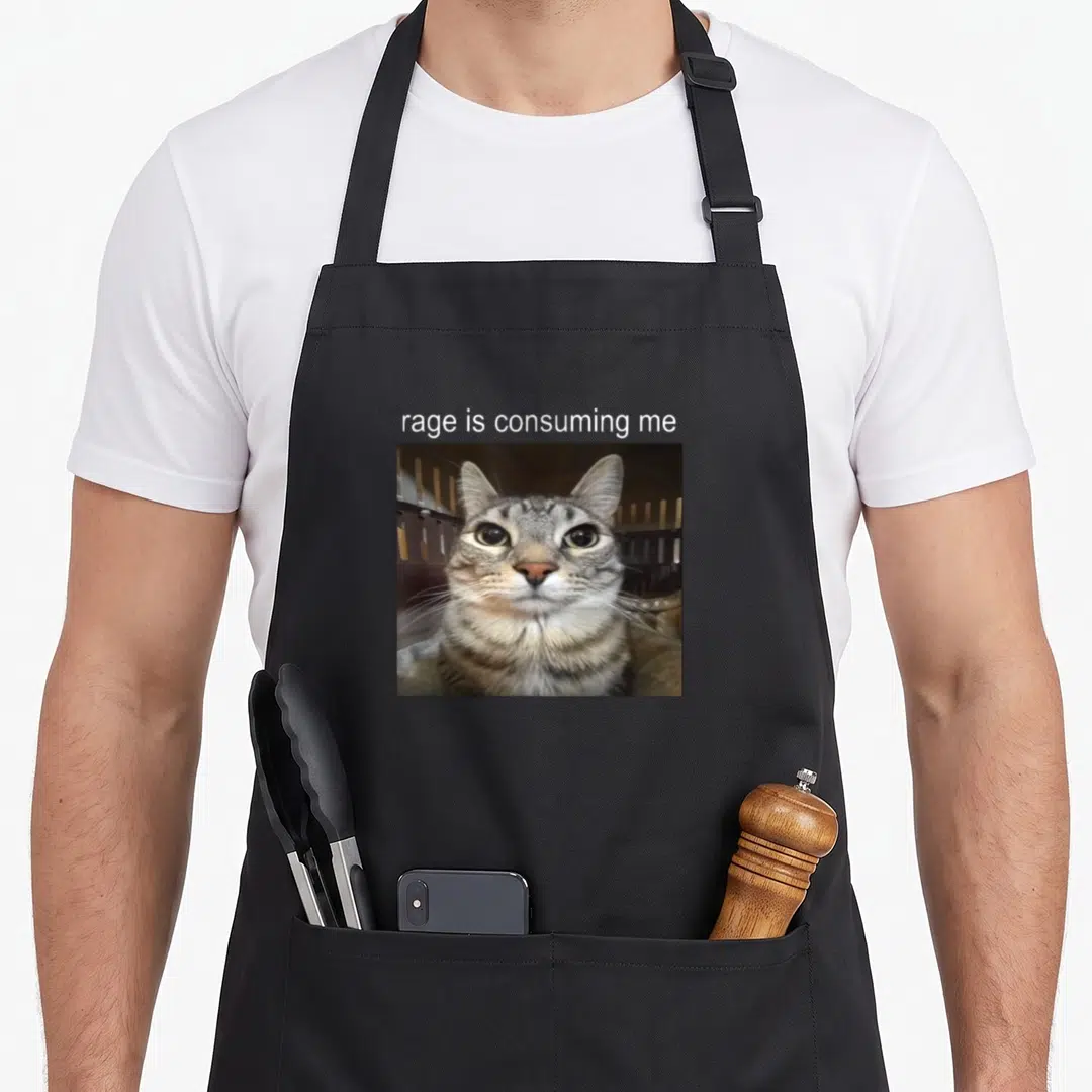 Rage cat apron - White text rage is consuming me above square photo of staring grey and brown tabby cat — shown on a black cotton canvas apron against a white background