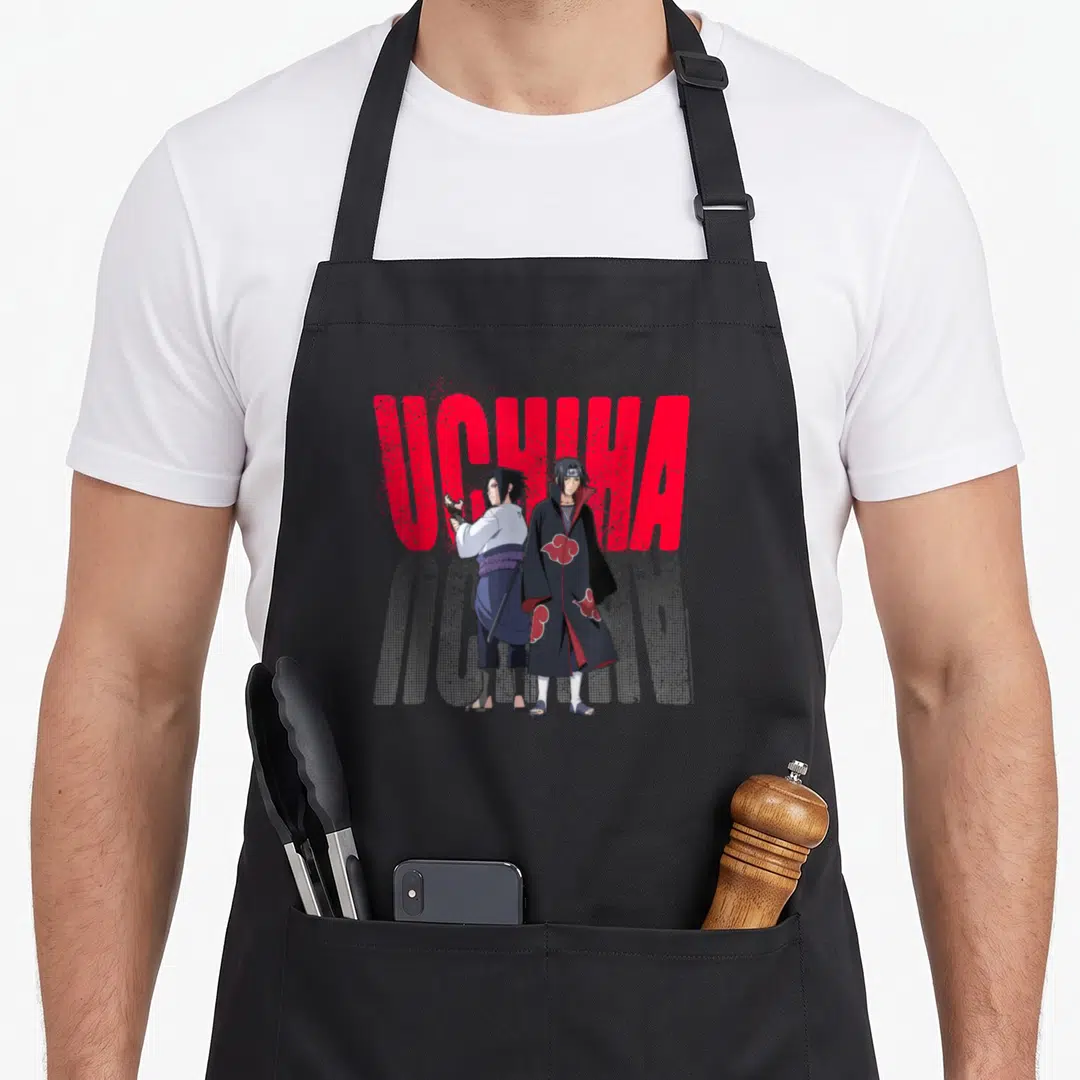 Uchiha anime apron - Two ninjas standing before red UCHIHA text with halftone reflection — shown on a black cotton canvas apron against a white background