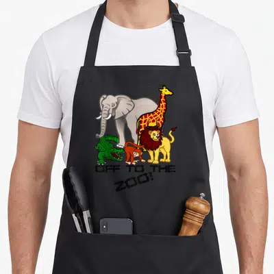 Trip animal apron - Five cartoon zoo animals with distressed OFF TO THE ZOO text — shown on a black cotton canvas apron against a white background