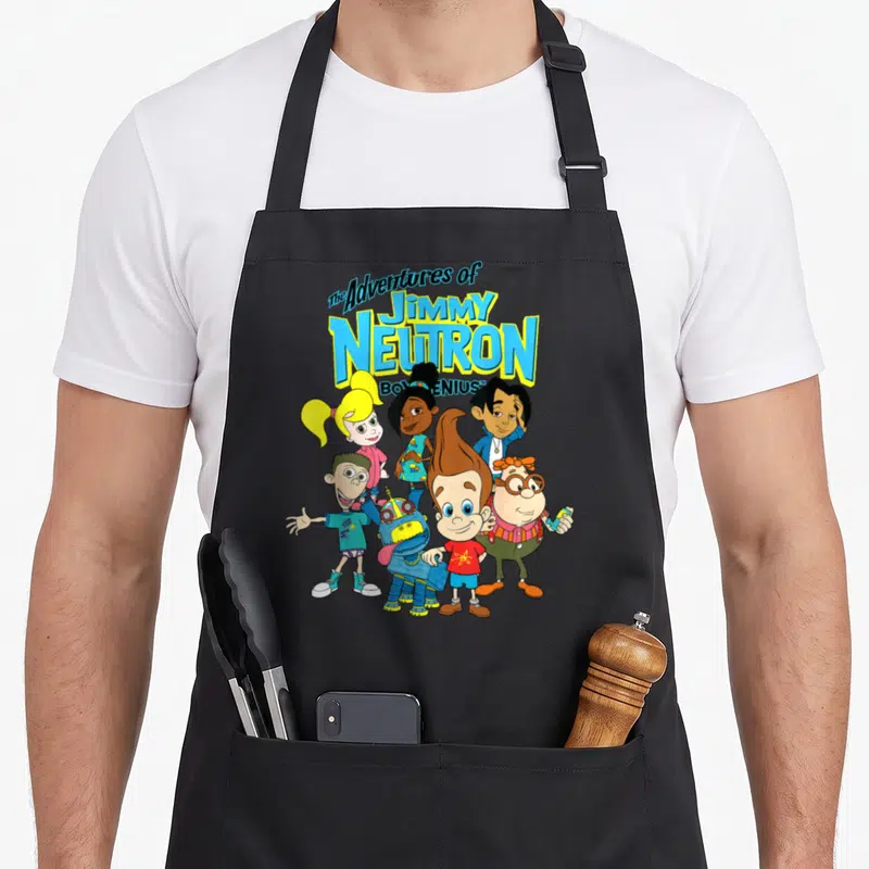 Adventure character aprons - Six cartoon characters standing below The Adventures of Jimmy Neutron Boy Genius title text — shown on a black cotton canvas apron against a white background