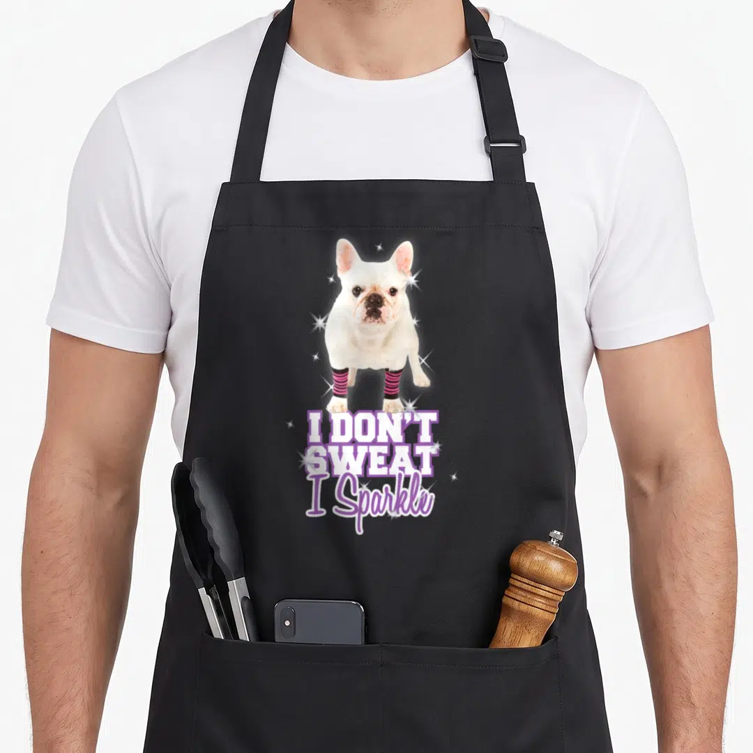 Workout french bulldog apron - White French Bulldog in pink striped leg warmers with I Don't Sweat I Sparkle text — shown on a black cotton canvas apron against a white background