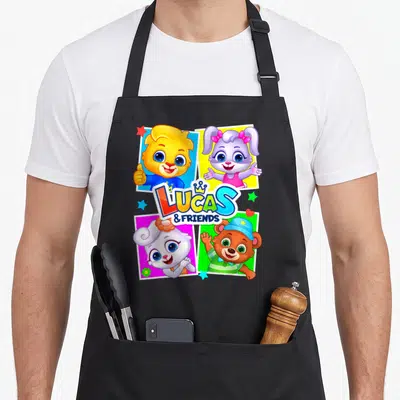 Lucas friends apron - Four cartoon animals in colored squares with LUCAS & FRIENDS text and crown — shown on a black cotton canvas apron against a white background