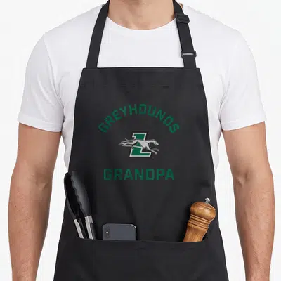 Loyola grandpa apron - Greyhounds Grandpa text with running greyhound logo in green and black — shown on a black cotton canvas apron against a white background