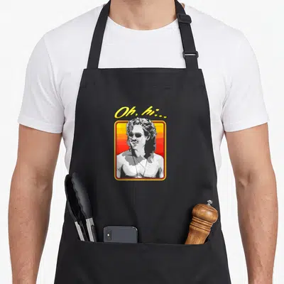 Boxed billy apron - Oh hi text above framed man portrait with yellow red grey white sunset background — shown on a black cotton canvas apron against a white background