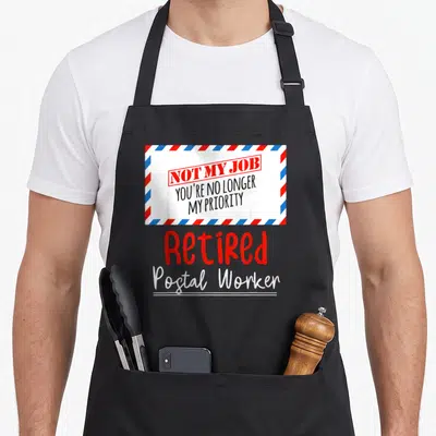 Post office retirement apron - Cartoon airmail envelope with text Not My Job and Retired Postal Worker — shown on a black cotton canvas apron against a white background