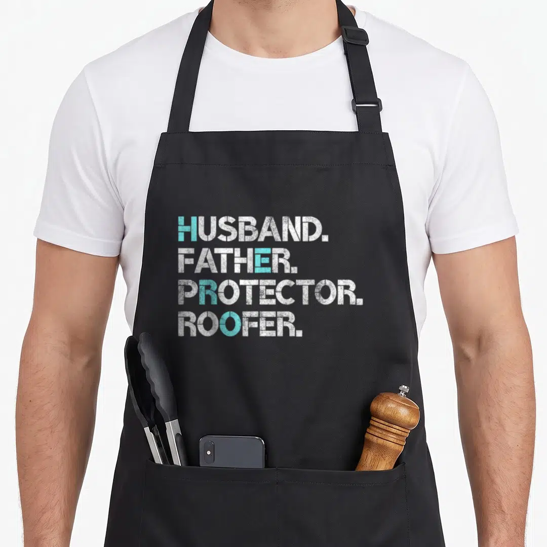 Husband roofing apron - White and blue text reading HUSBAND FATHER PROTECTOR ROOFER stacked vertically — shown on a black cotton canvas apron against a white background